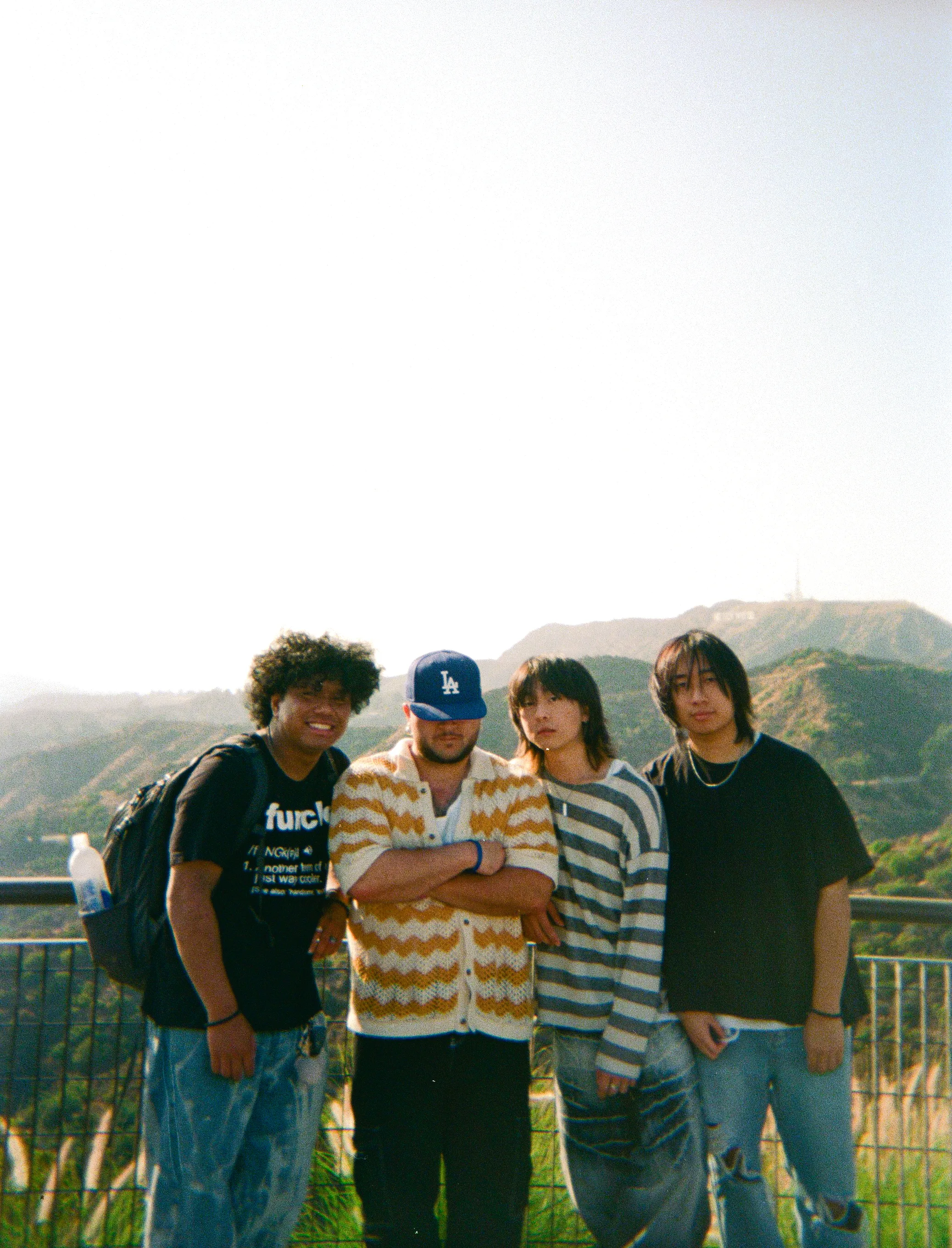 photo of 5 members on a beach near the water